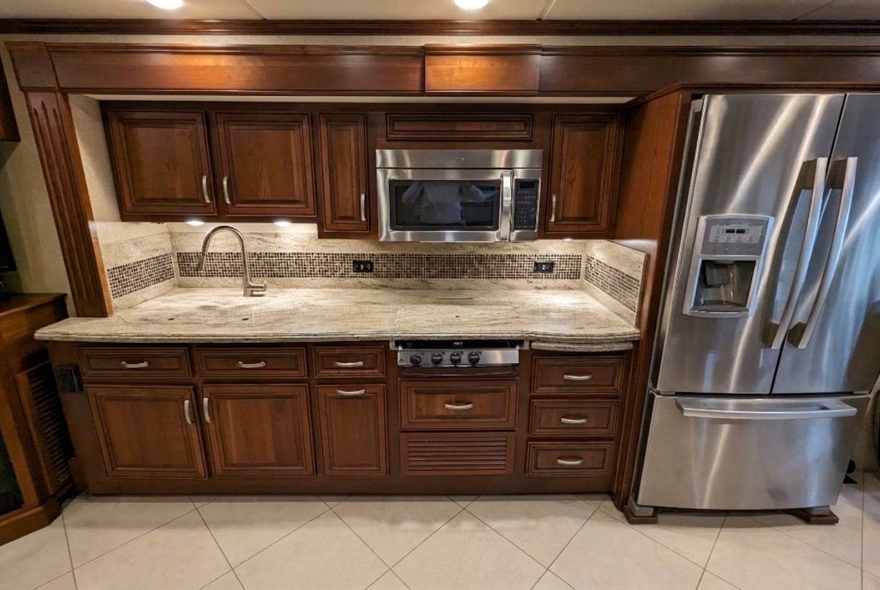 Granite kitchen counters with three-burner cooktop and over-range microwave